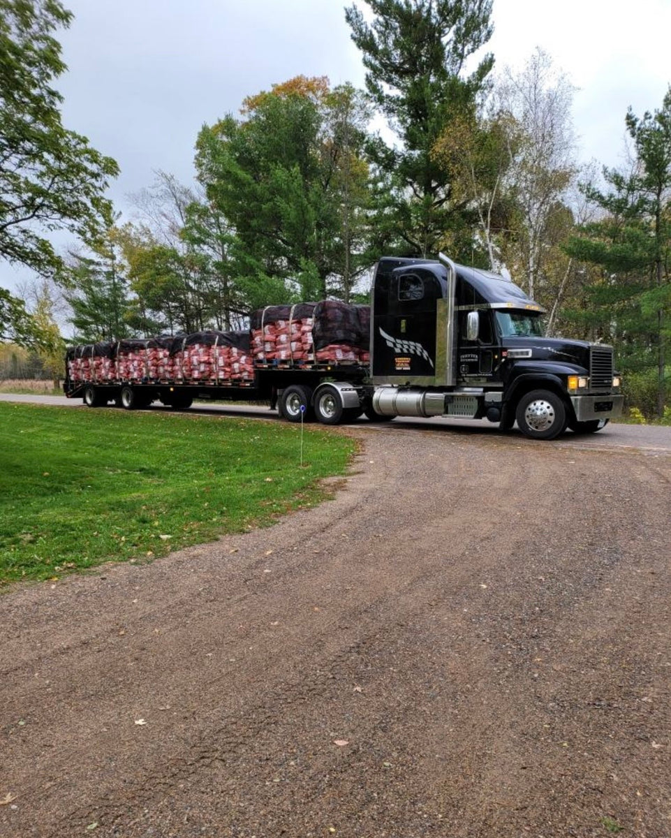 Semi truck with Minnesota Firewood as the cargo. Its being delivered by semi